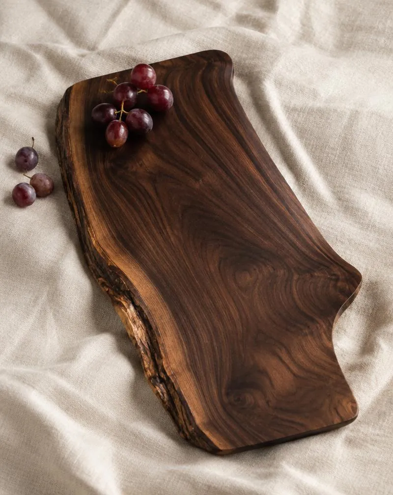 Dark walnut serving board with a live edge